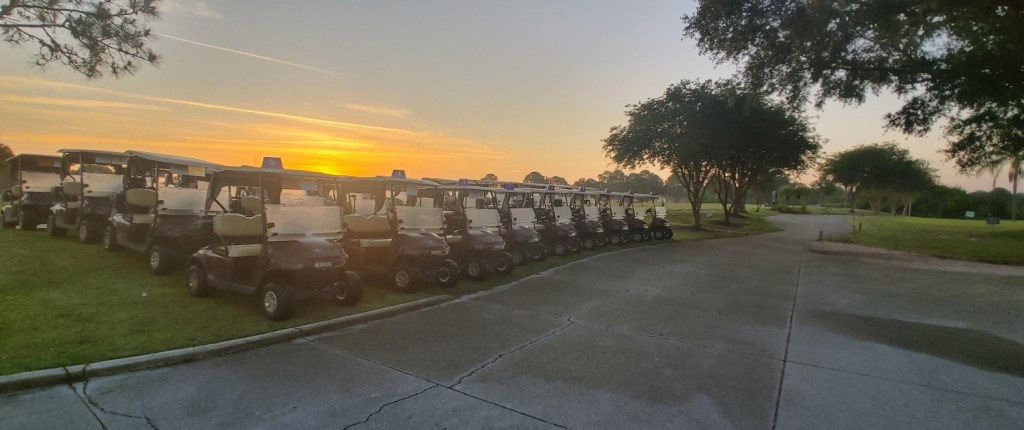 Row of golf carts at sunset